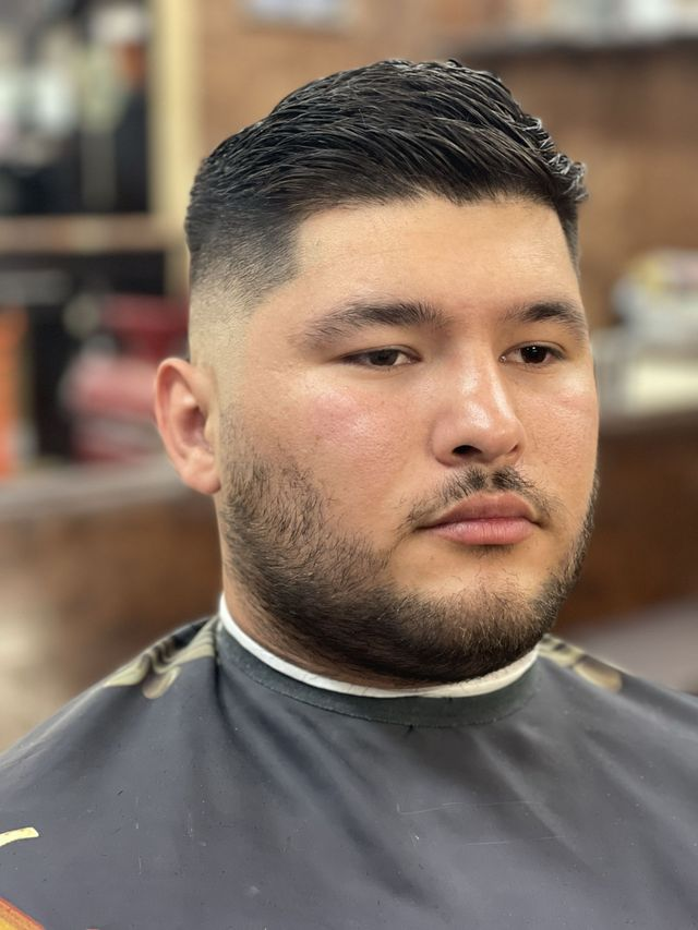 Slicked-back fade and beard grooming — JM Barber Co., Lake Park, Florida Slicked-back fade and full beard at JM Barber Co., Lake Park, FL